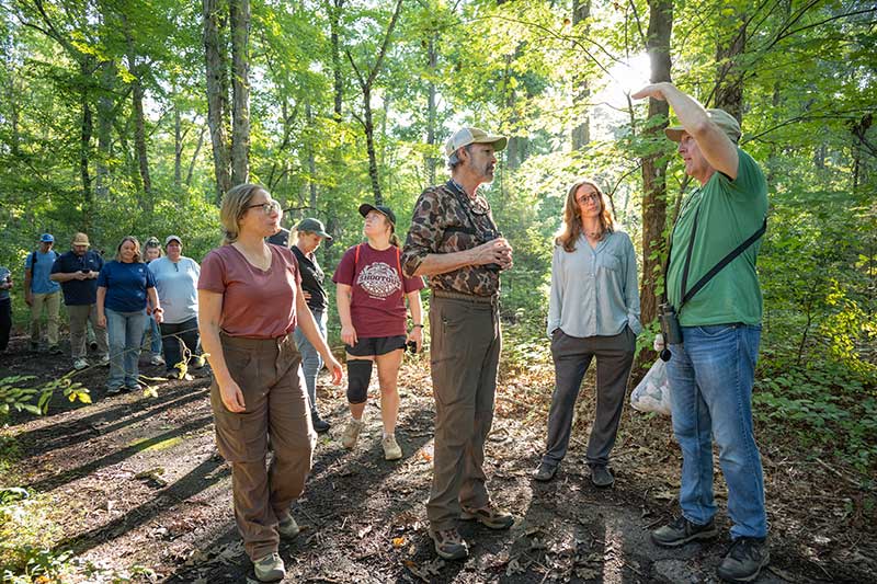 TVA biologists and Dr. Aborn from the University of Tennessee-Chattanooga instruct volunteers on how to safely catch and release birds from mist nets.