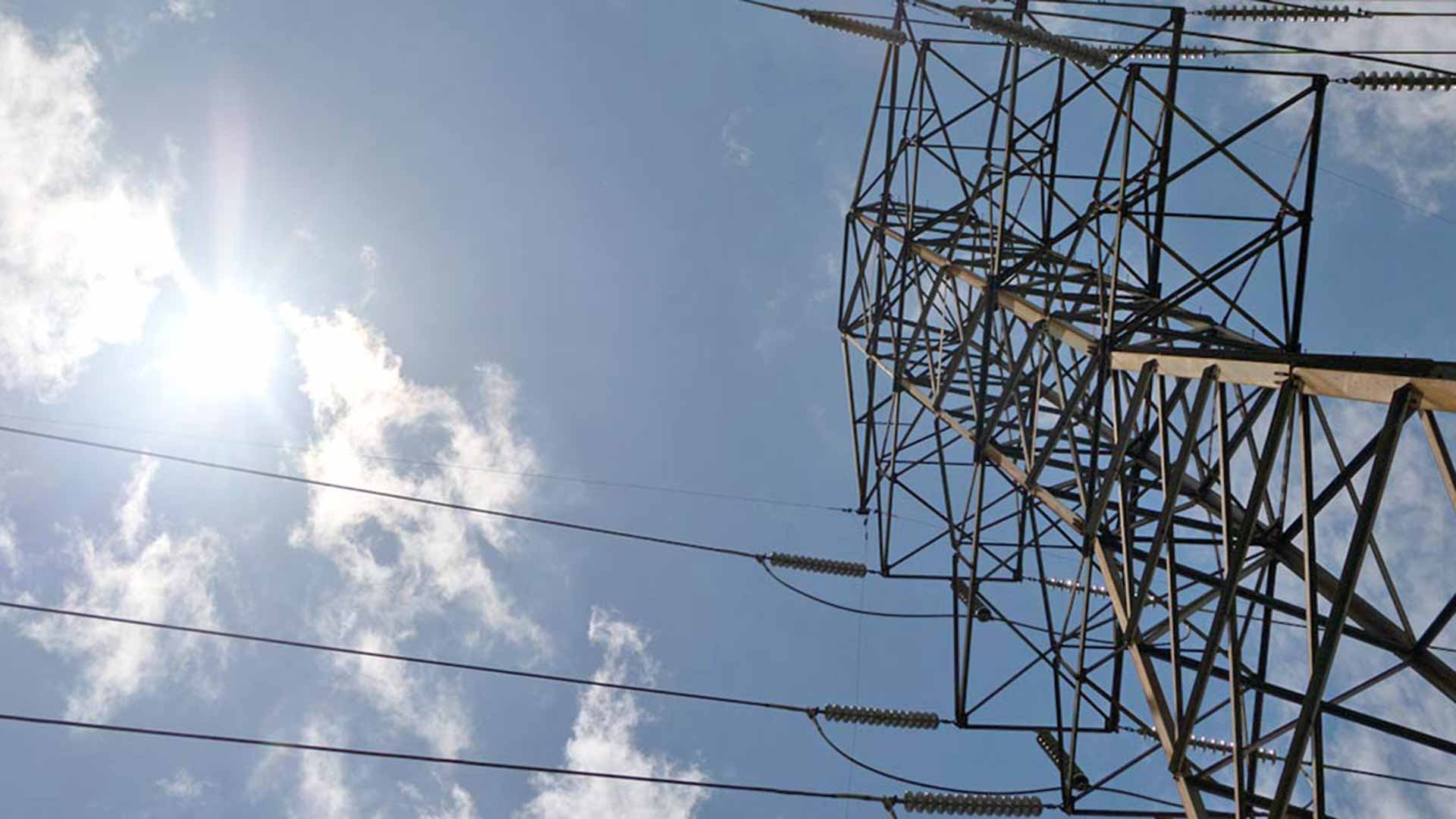 Transmission tower against a blue sky