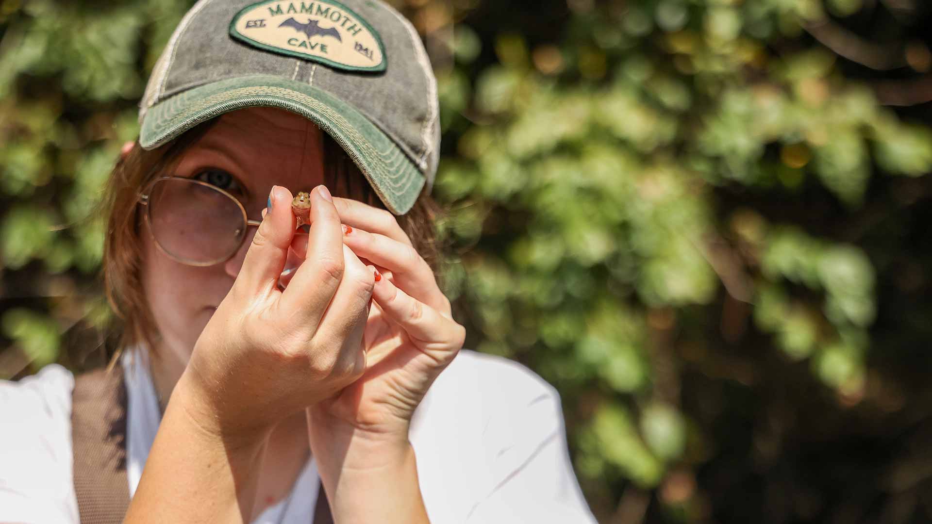 Student looking closely at macroinvertebrate