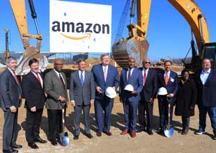 Group of people standing in front of construction equipment