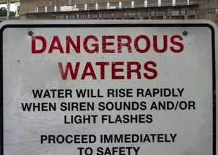Sign board that says Dangerous Water