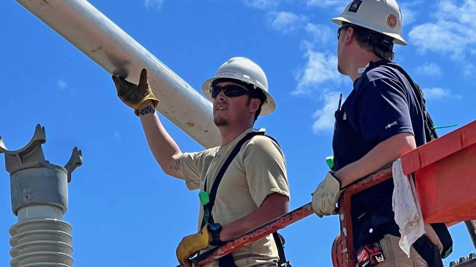 TVA electrician apprentices at work in the field