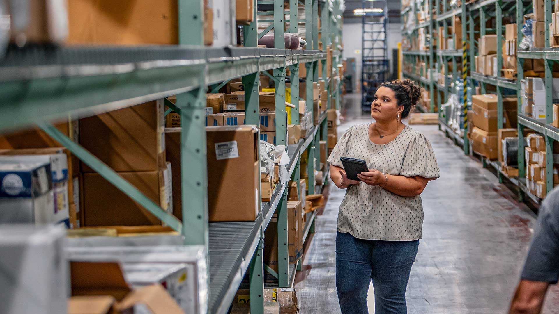 TVA's Hailee Robinson locates equipment in a warehouse.