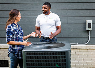 Man and woman having discussion by heat pump