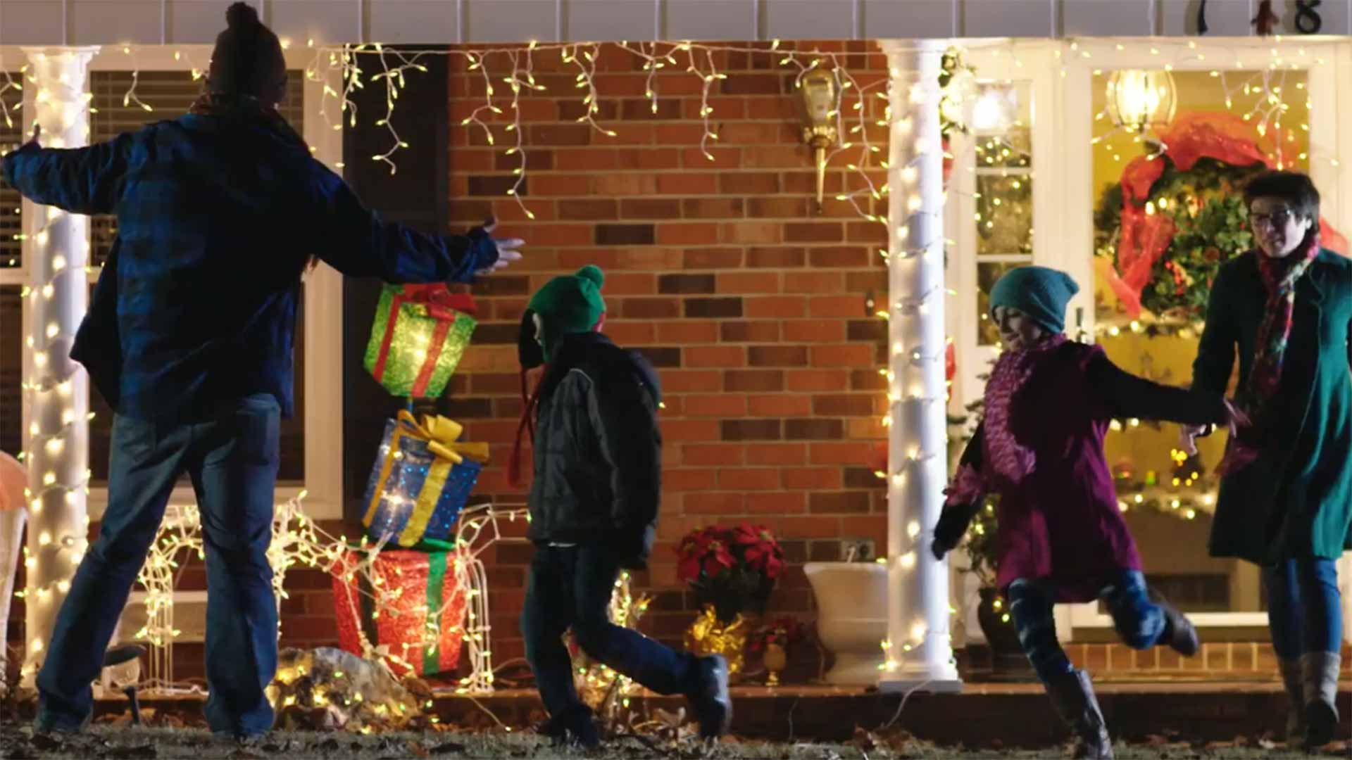 Family running outside to see Christmas lights