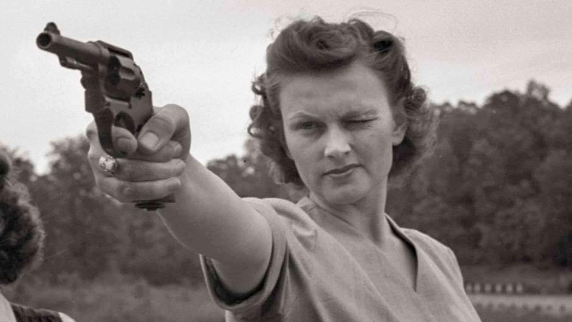 Woman aiming pistol