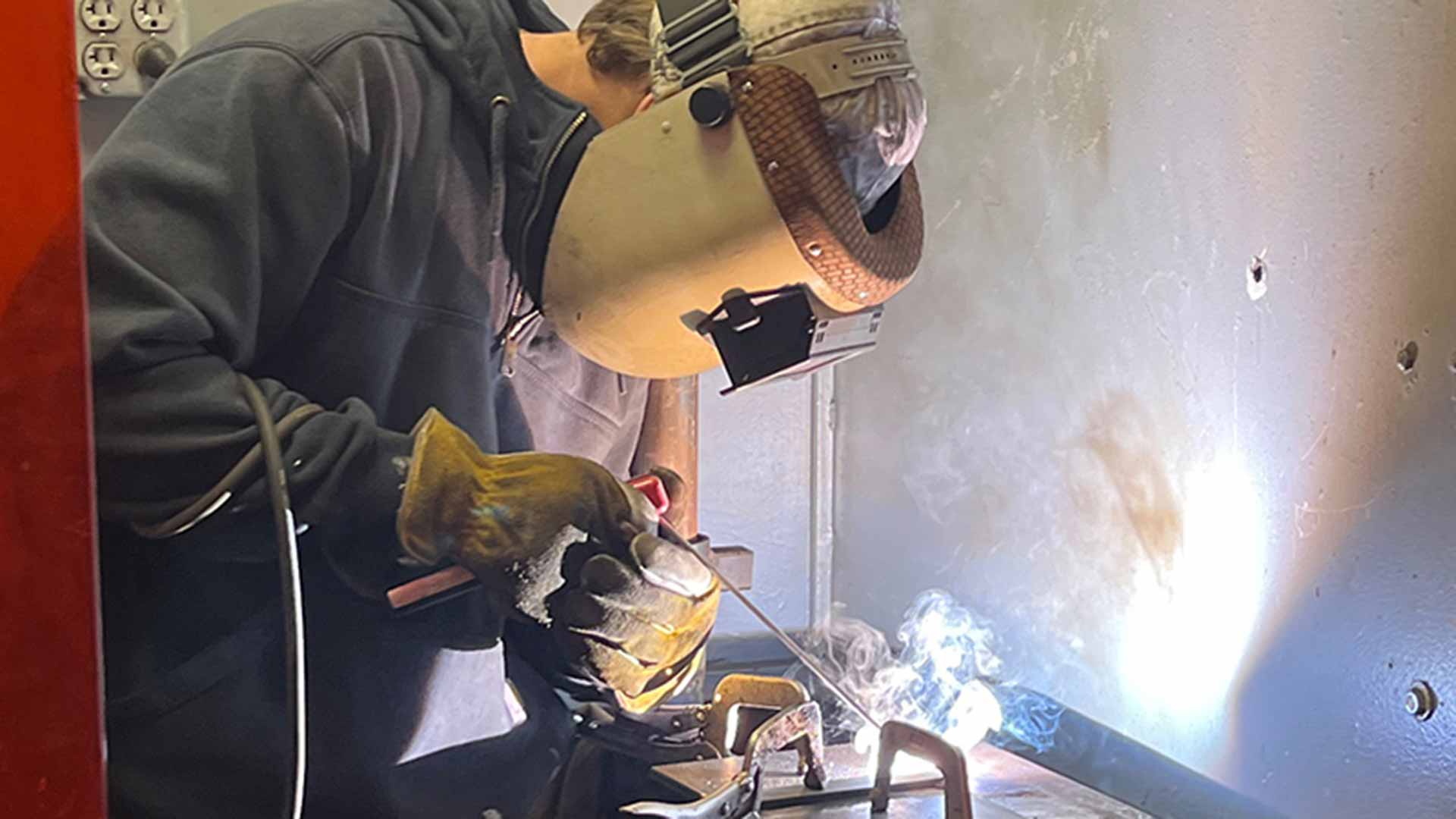 Student demonstrates welding during competition.