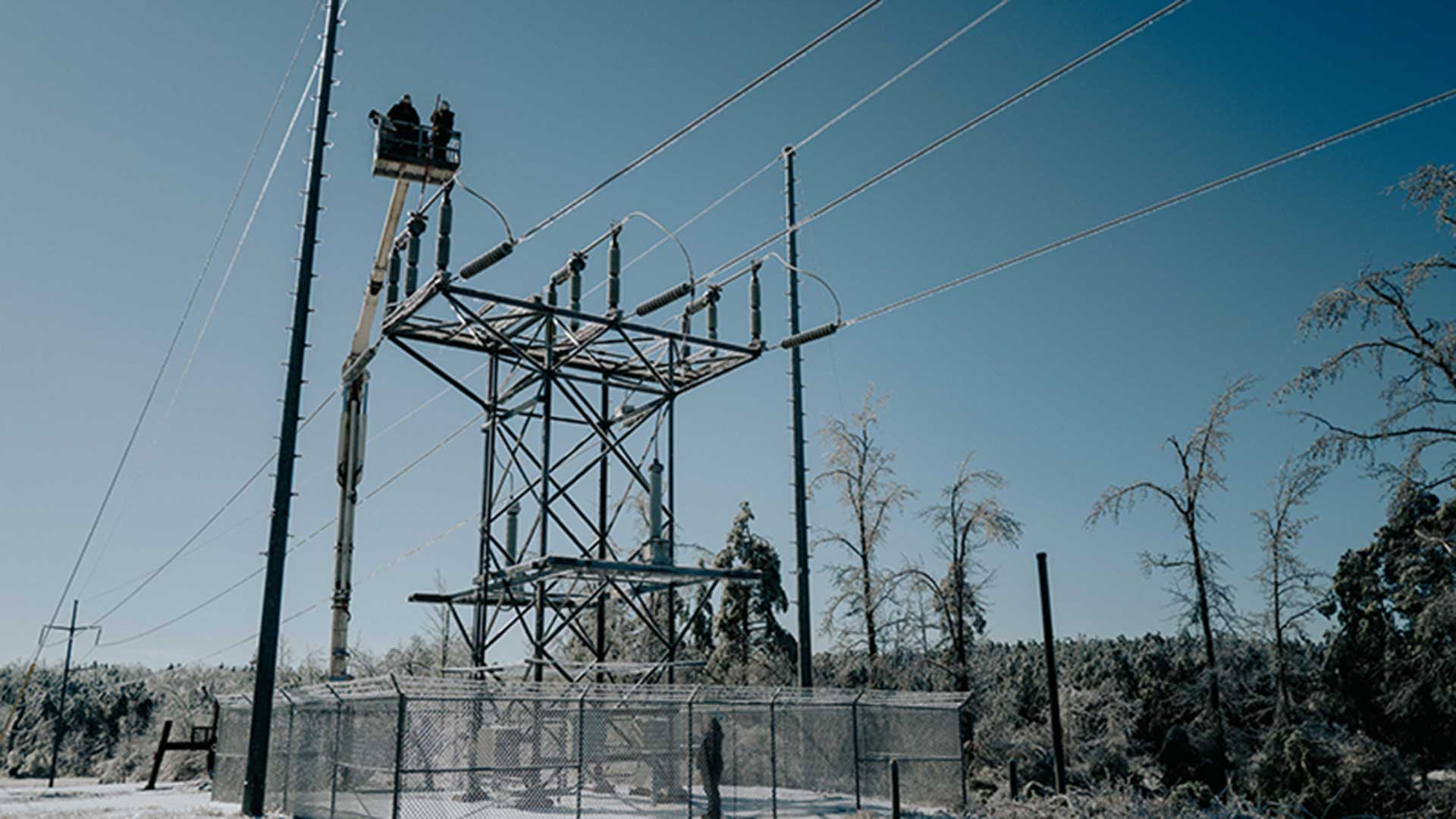 Lineworkers in Mississippi work atop a power substation following Winter Storm Fern