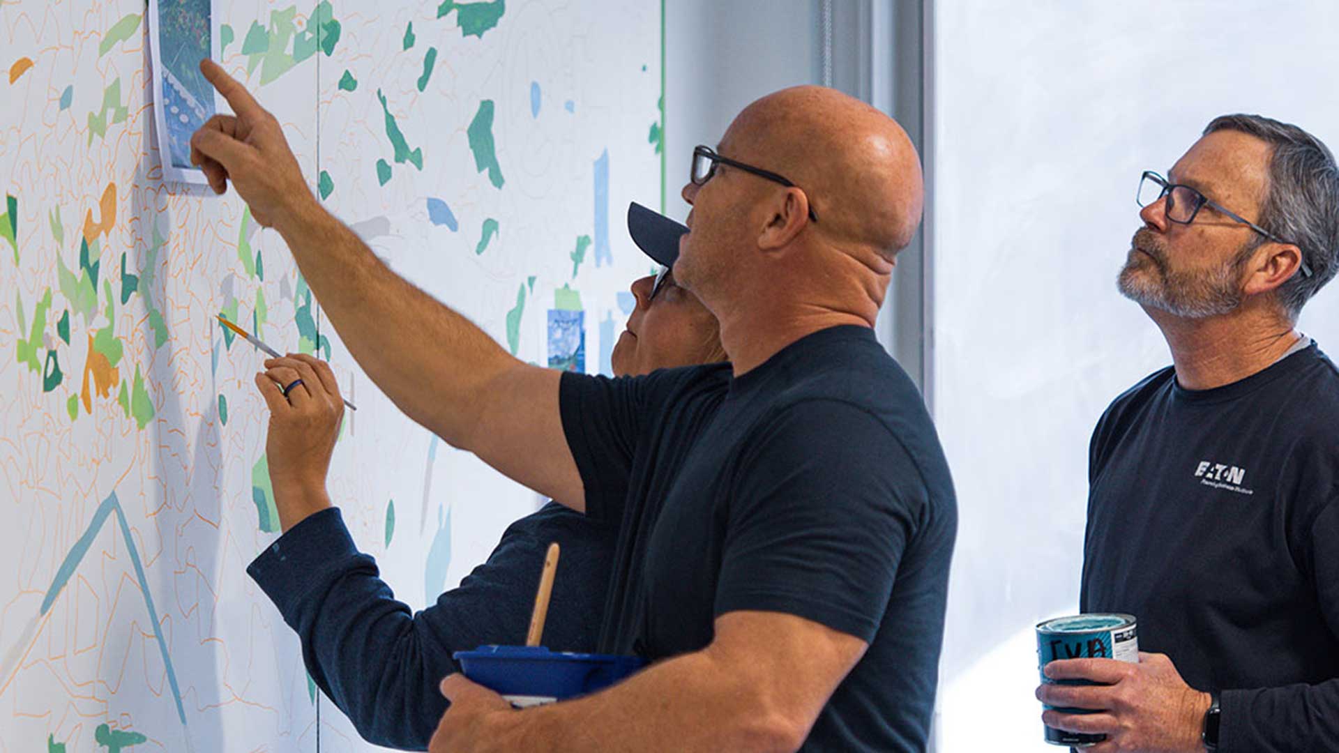 TVA employees painting mural at Raccoon Mountain Pumped Storage facility near Chattanooga
