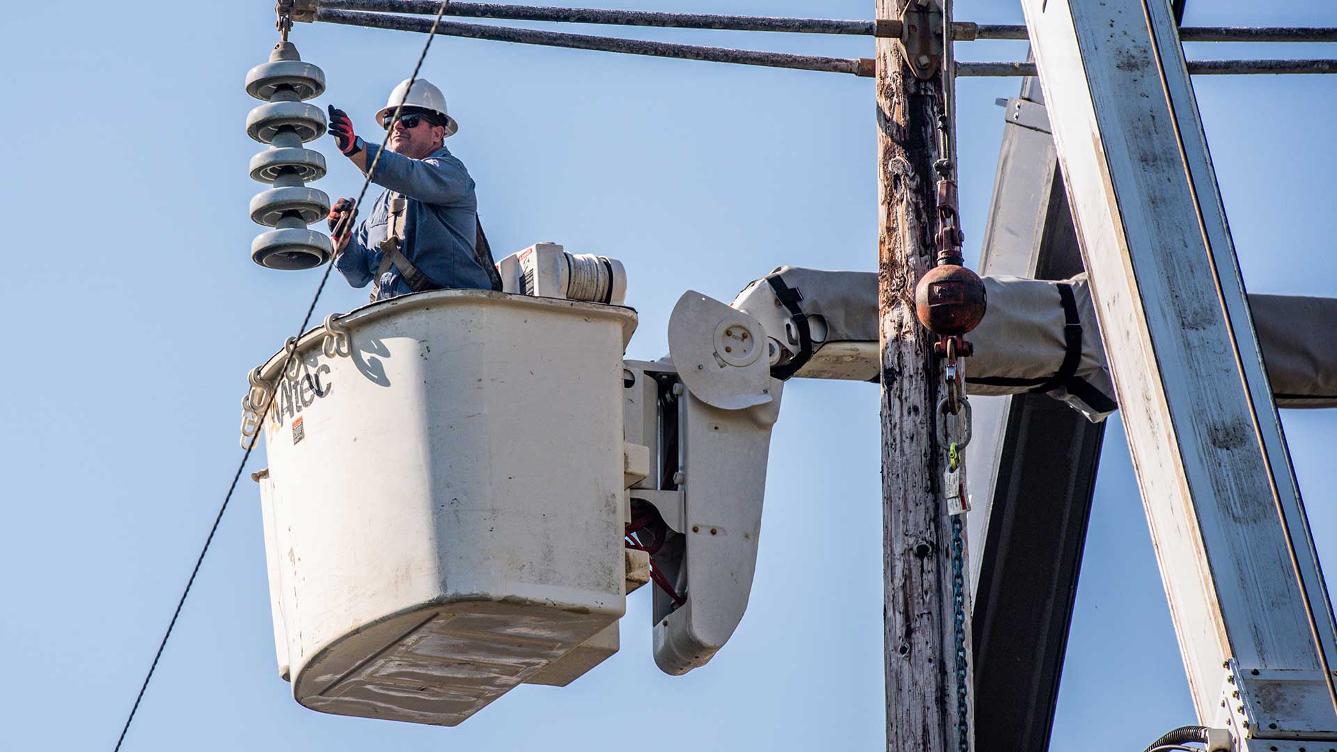 TVA lineworker in a bucket lift working on a powerline