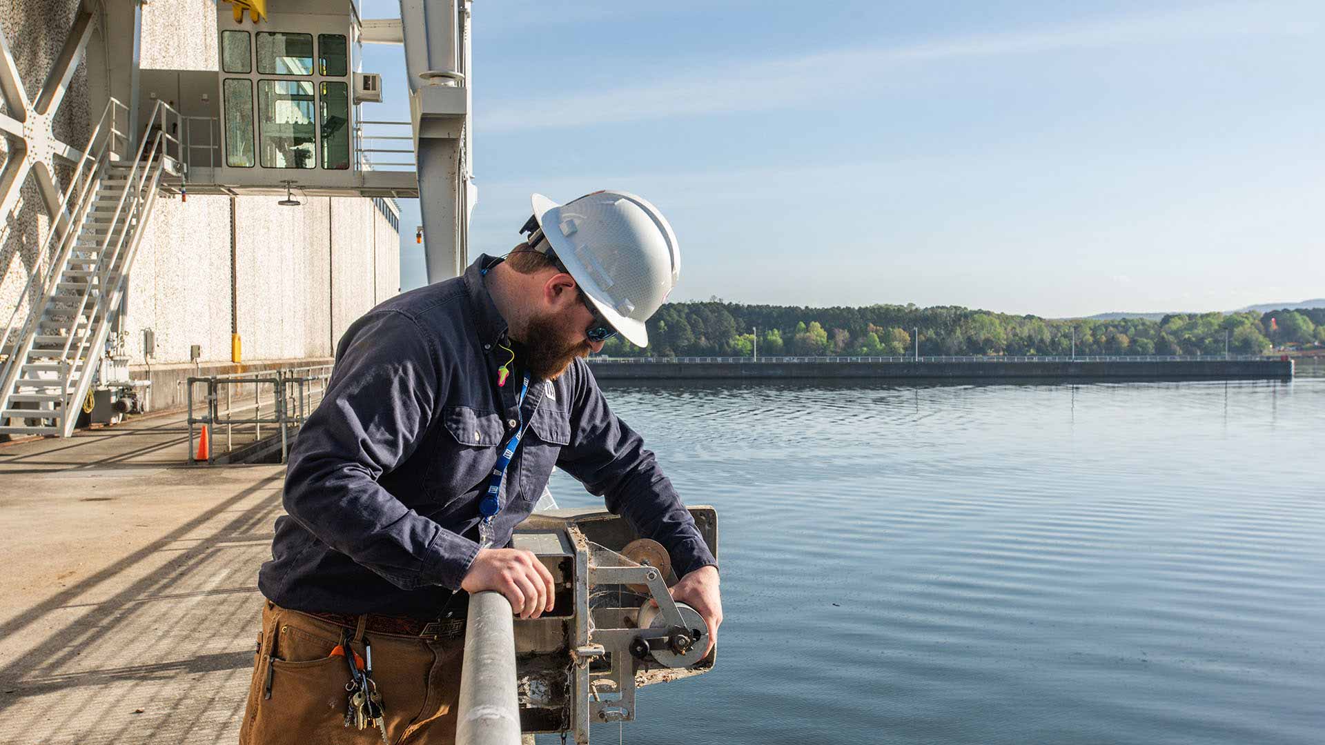 TVA engineering technician Brandon Boyd checks a wire weight rain gauge at Nickajack Reservoir.