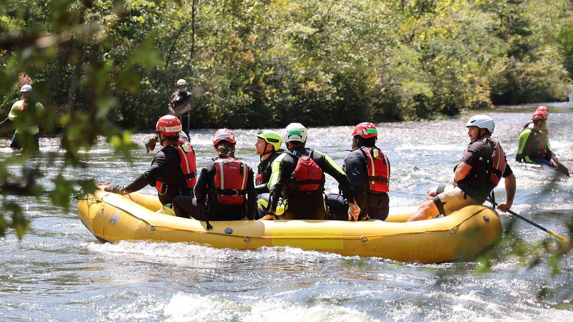 Swift-water rescue training participants in raft on Ocoee River