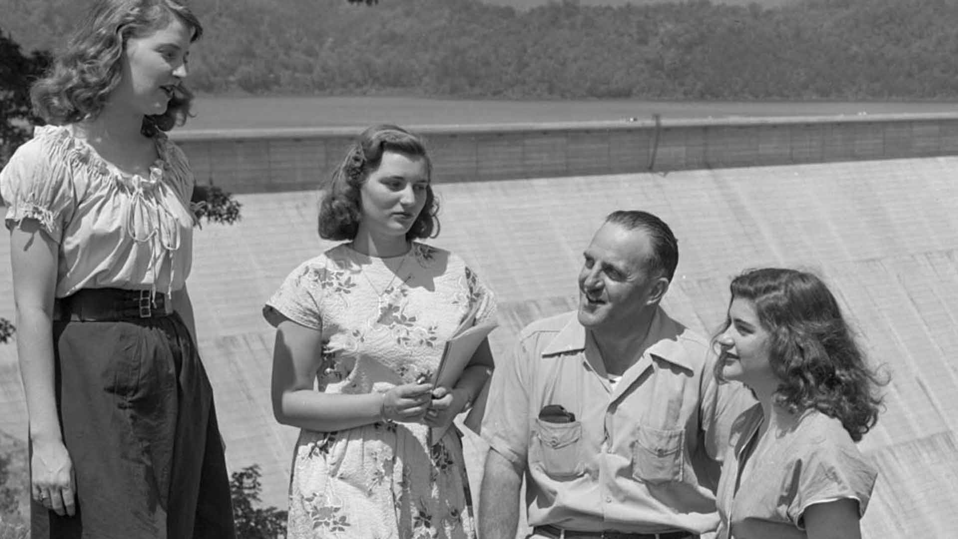 People standing at overlook with Fontana Dam in the background
