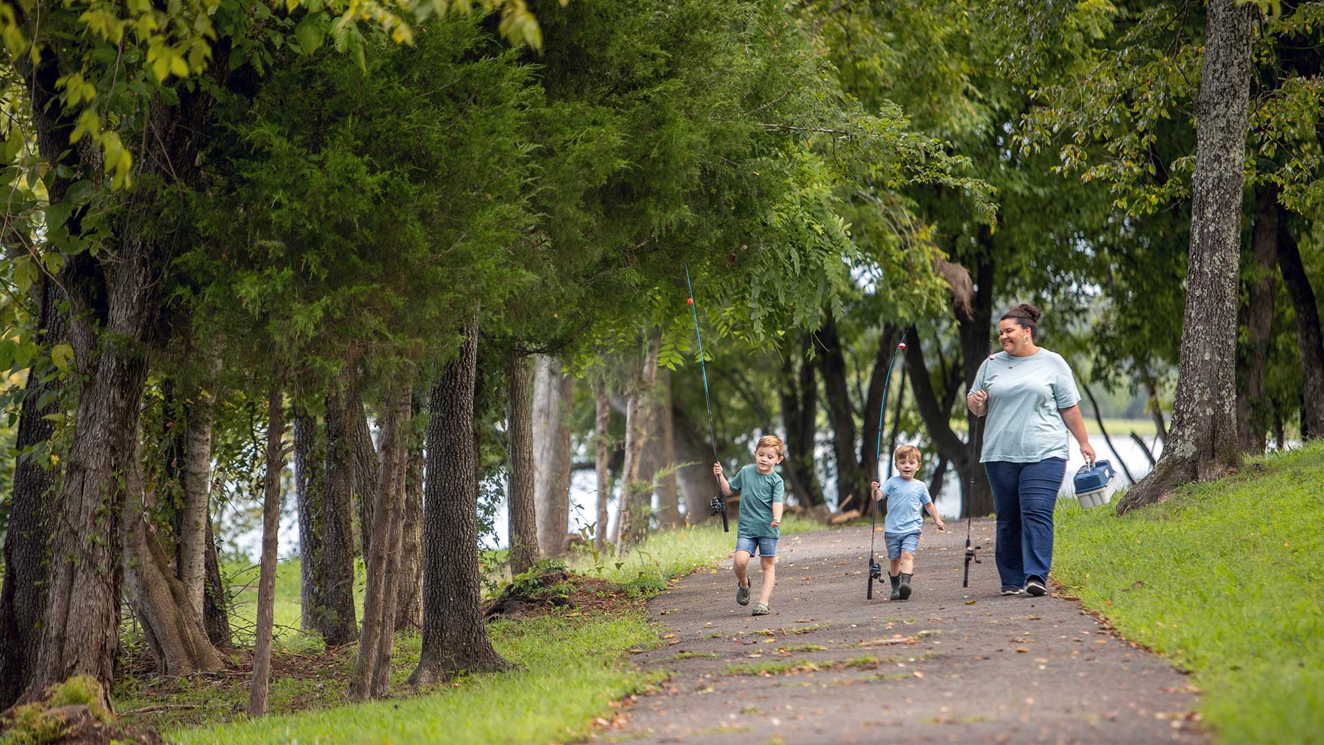Family on trail with fishing poles