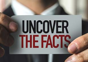 Man showing a note that says uncover the facts