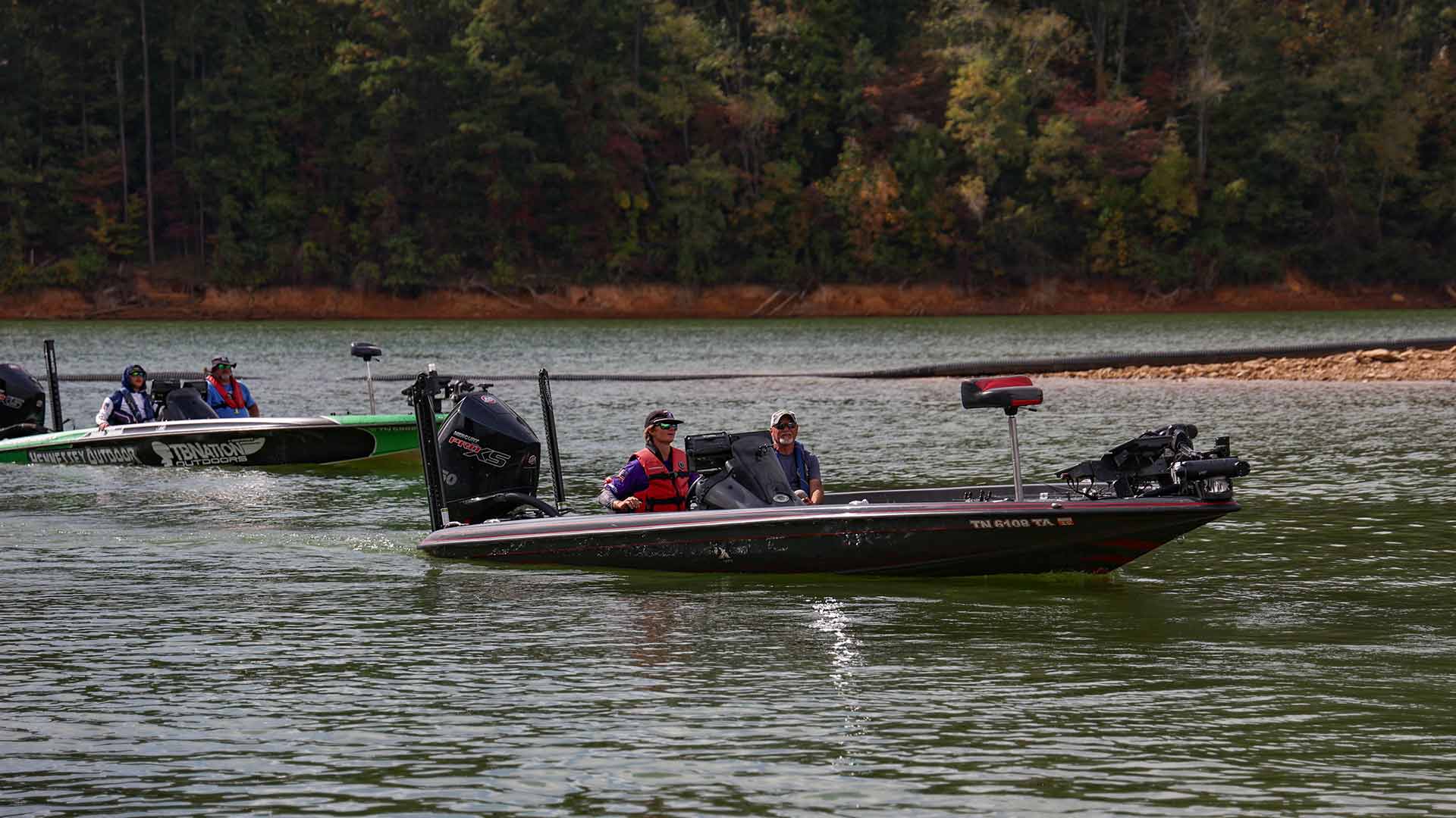 Boats of anglers return to the shores of Watauga Reservoir.