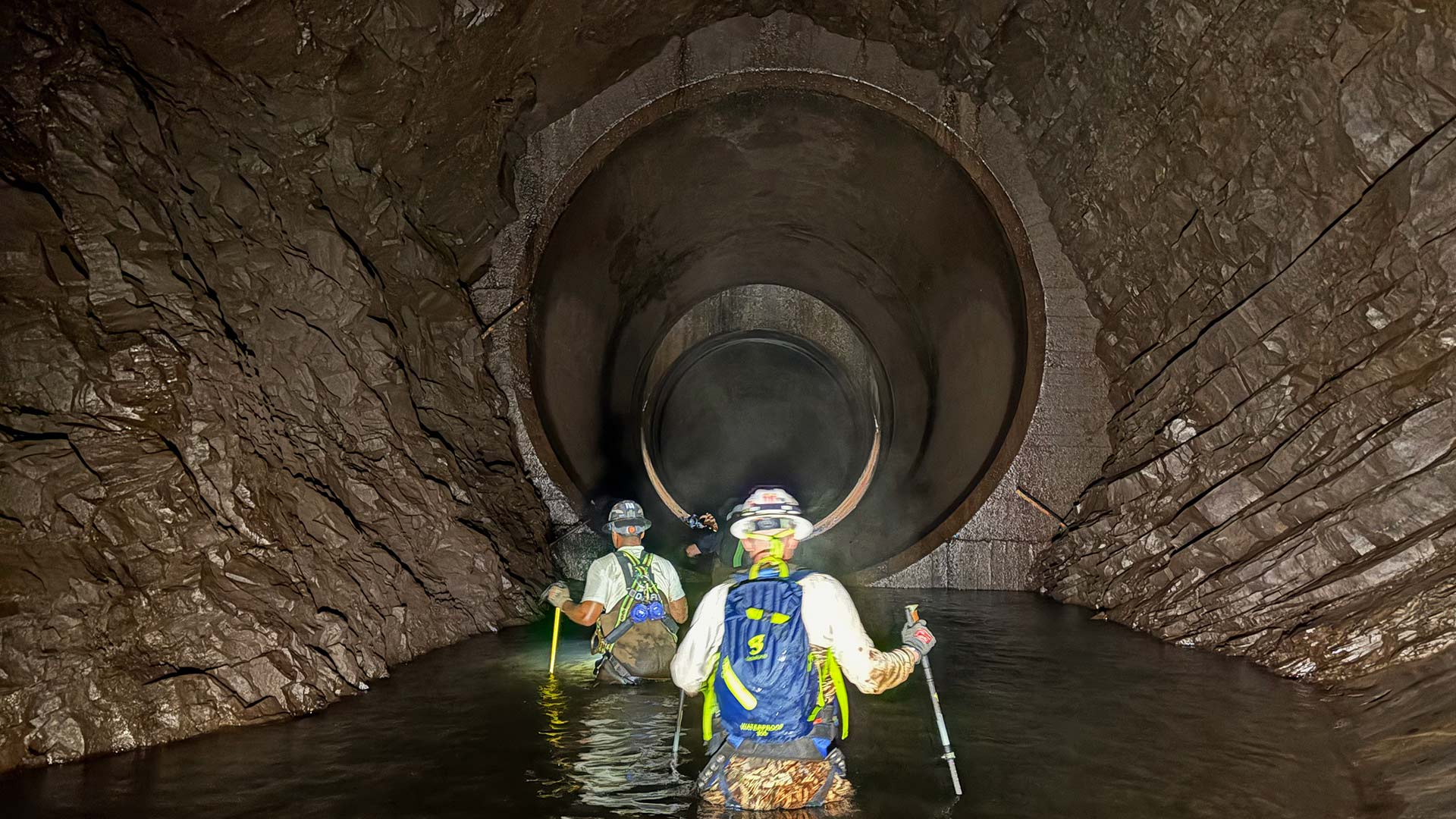 Dam Safety crew members in the penstock, which stretches 3,700 feet through Iron Mountain.