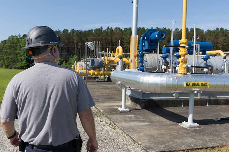 Manager inspects natural gas pipeline
