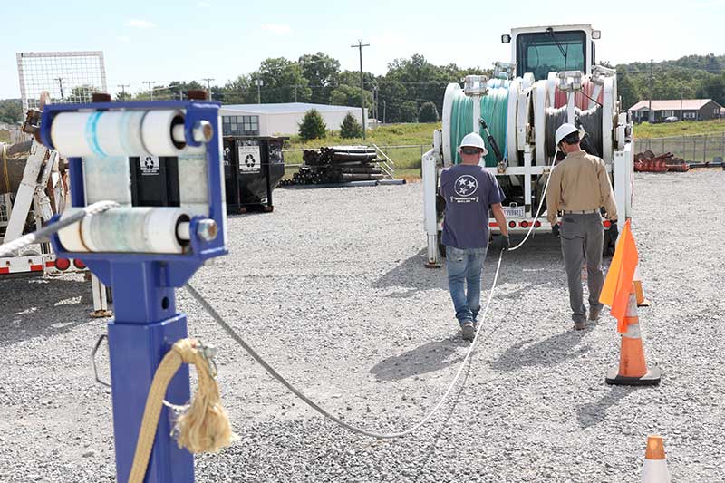 Guiding rope from trailer through the inspection facility.