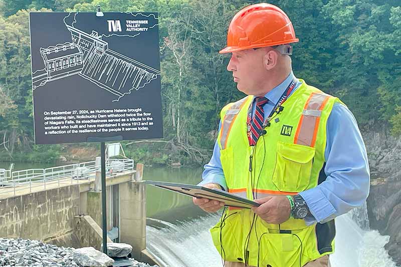 Kevin Morrison, mayor of Greene County, reads a proclamation in front of Nolichucky Dam.