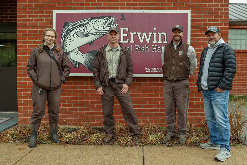 Group standing in front of Erwin National Fish Hatchery sign
