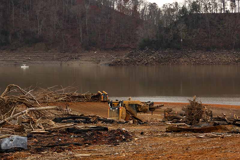 Skid Steer piles up debris