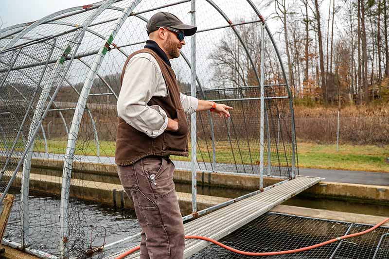 Tyler Hern in front of a trout raceway