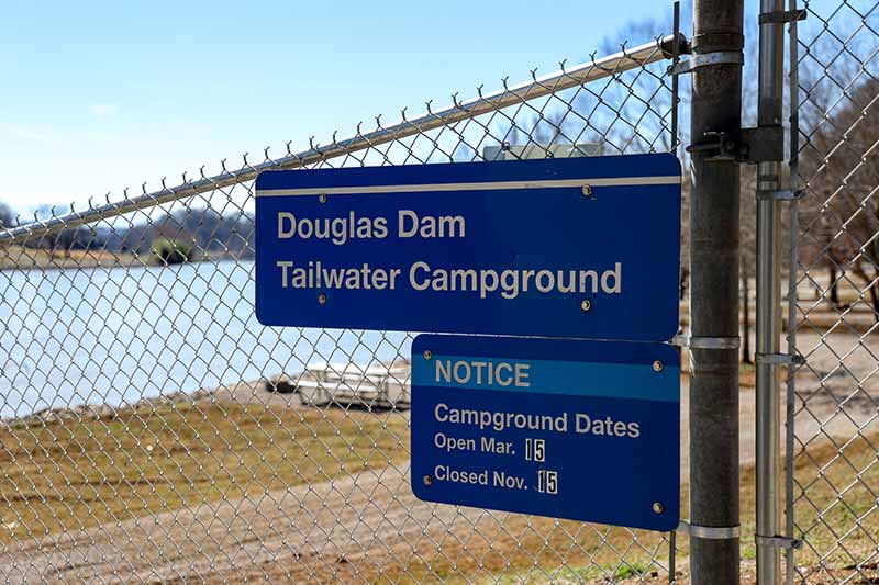 Sign on fence with open dates