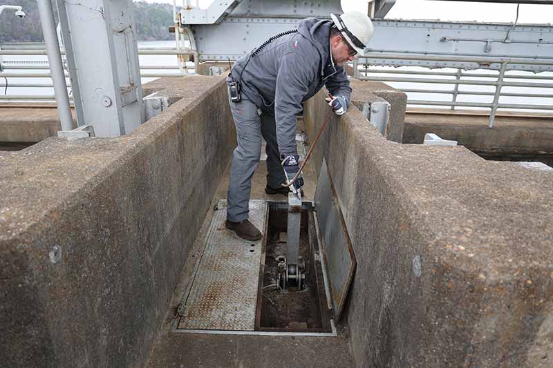 Brian Bain operates device to keep floodgate out of the water