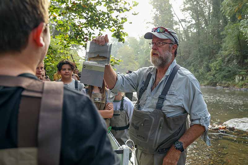 Dave Matthews holds up fish sample