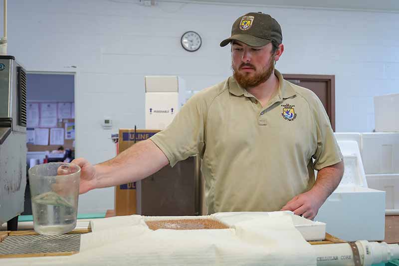 Colt Brewer at Erwin National Fish Hatchery packs brook trout eggs to ship to Dale Hollow Fish Hatchery