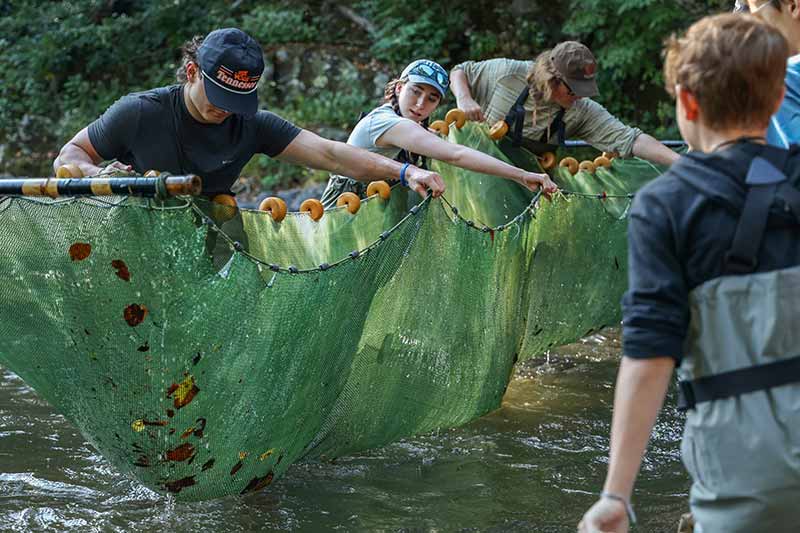 College students hold seine net