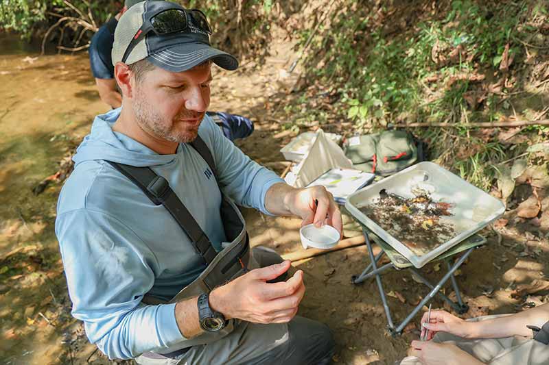 Justin Wolbert with macroinvertebrates