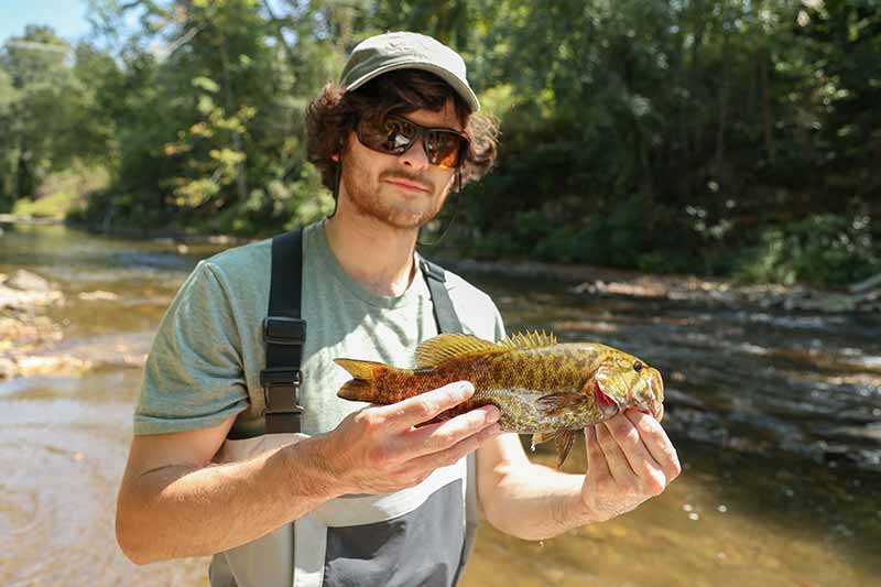 Quentin LaChance shows a healthy fish from the Pigeon River
