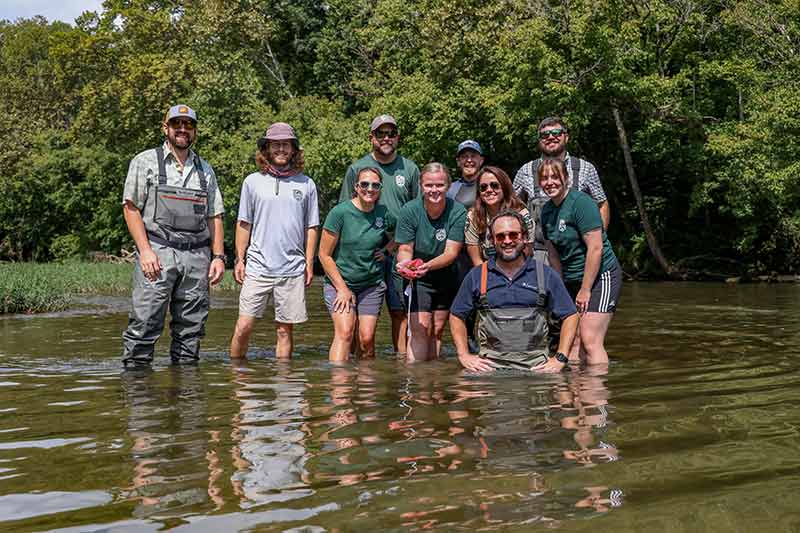 Group standing in stream
