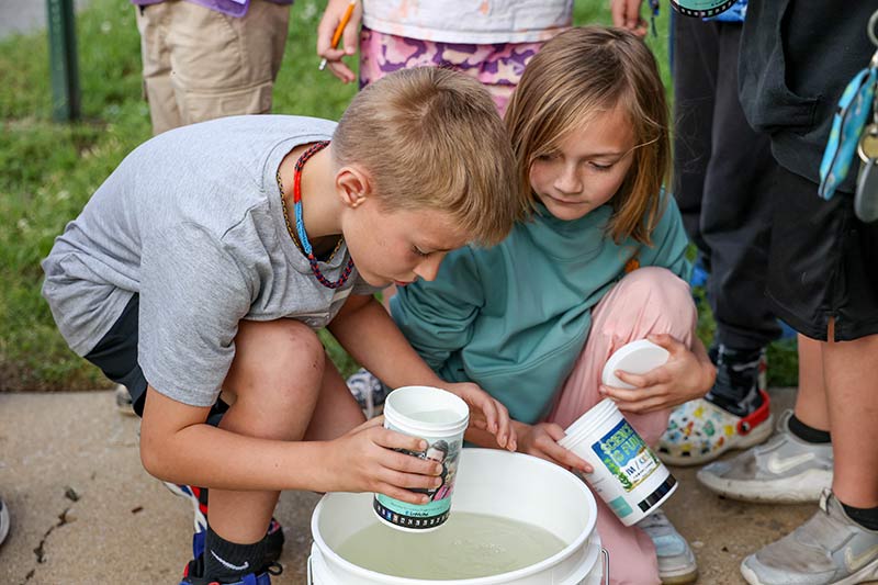 Students work together to measure water temperature.