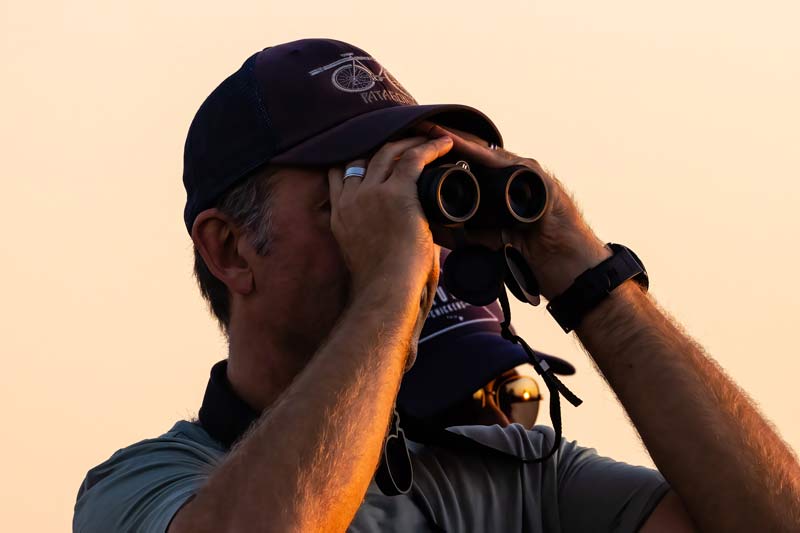 A birdwatcher peers through binoculars while visiting a TVA reservoir