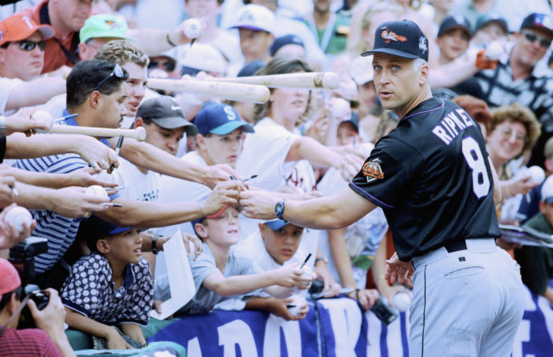 Cal Ripken Jr. signs autographs for fans during the MLB All-Star Game at Coors Field on July 7, 1998, in Denver, Colorado