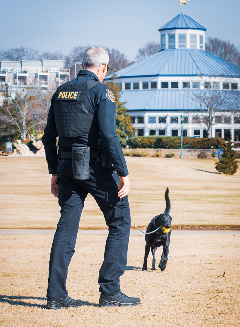 TVA Inspector Thomason plays with K-9 Jet at Coolidge Park in Chattanooga.