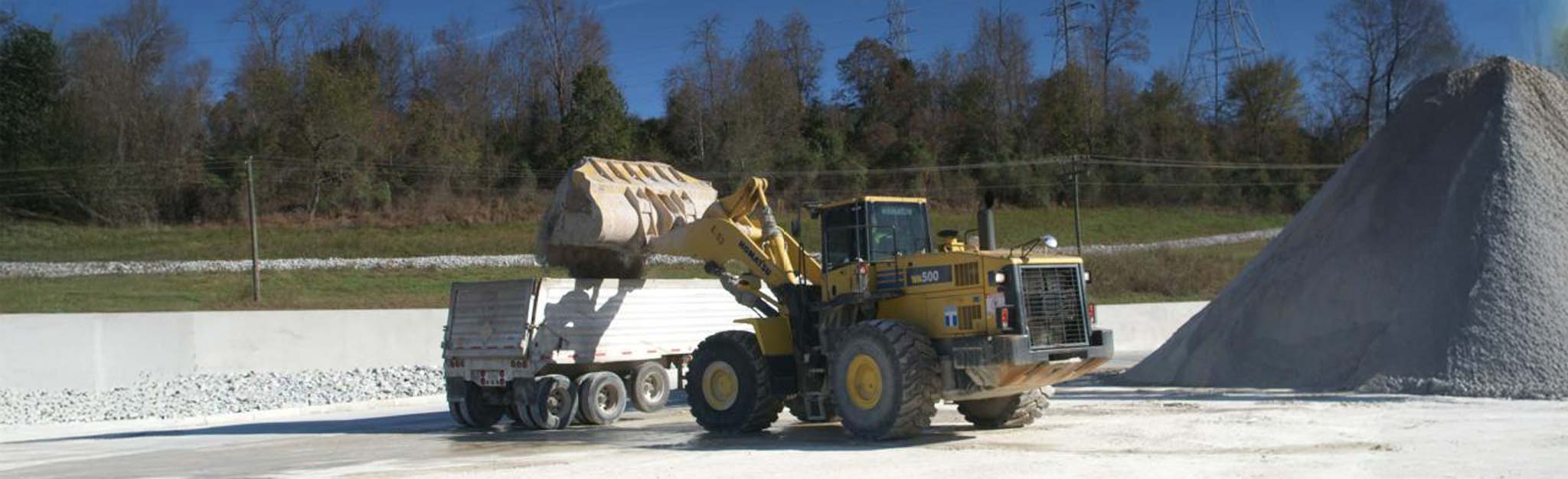 Loader filling truck with coal combustion byproducts