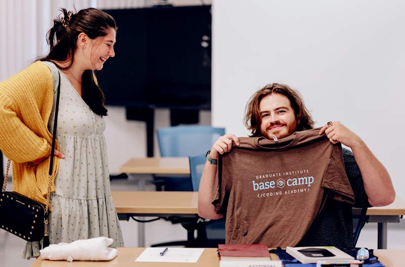 Student showing base camp code T-shirt