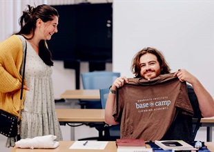 Student showing base camp code T-shirt
