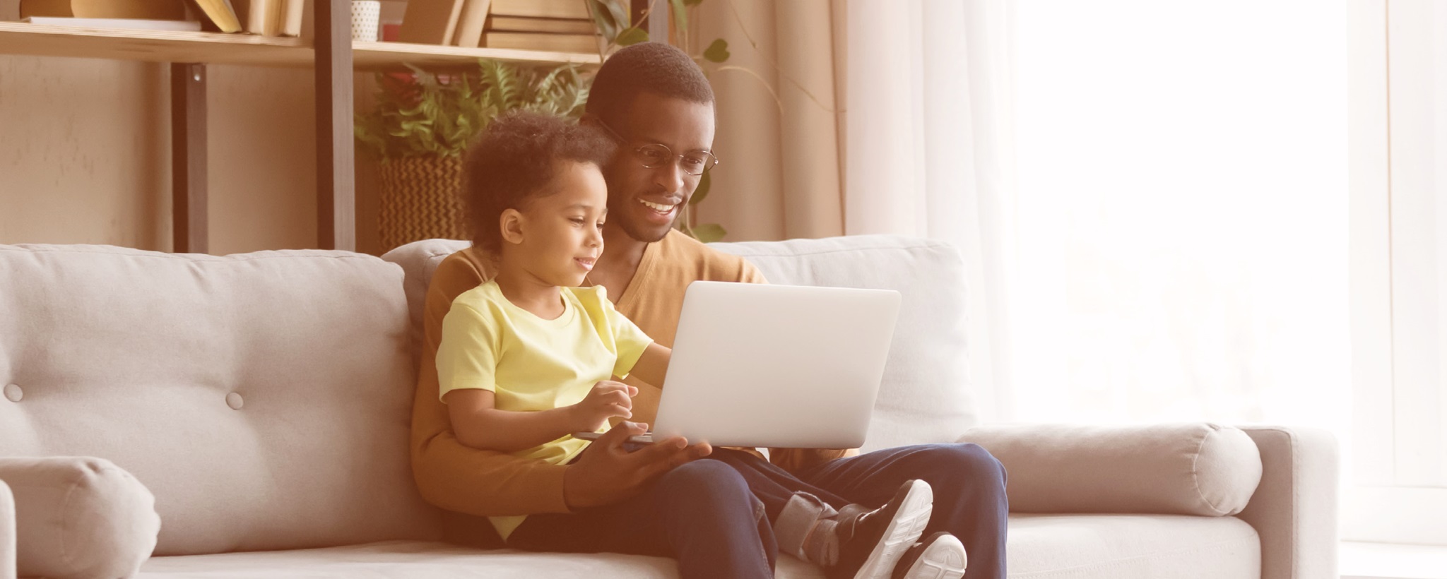 Father and son looking at the laptop screen Father and son looking at the laptop screen