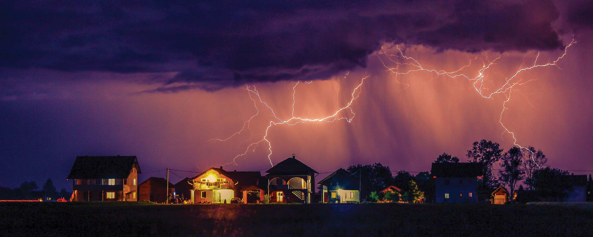 Lightning storm over residential neighborhood at night Lightning storm over residential neighborhood at night
