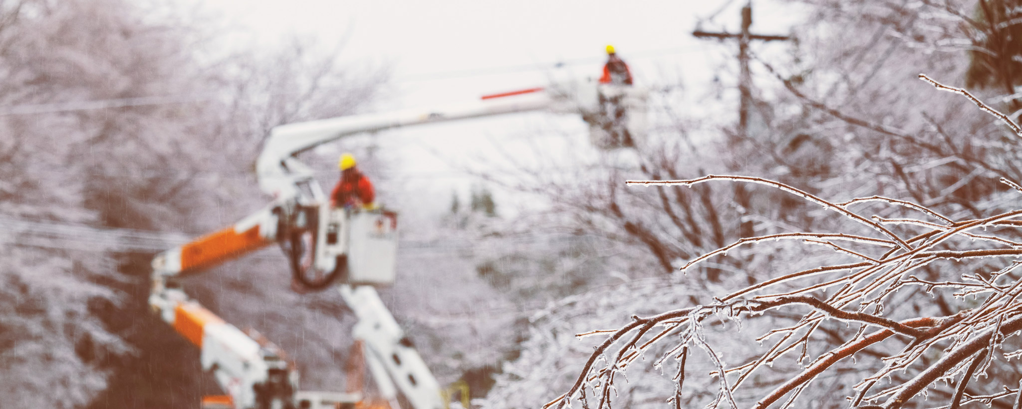 Linesmen working to restore power during an intense ice storm
