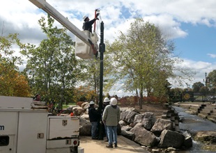 Workers installing smart poles