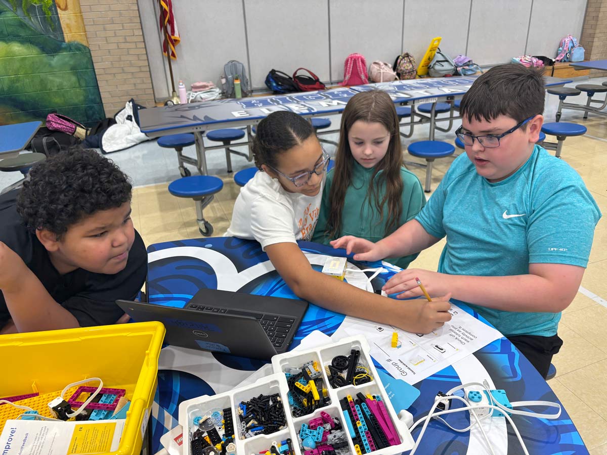Students working together on a robotics project in a classroom.