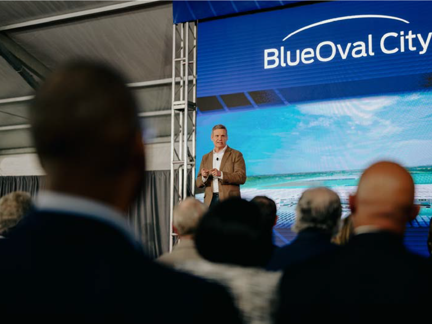 Speaker addressing an audience at a BlueOval City event