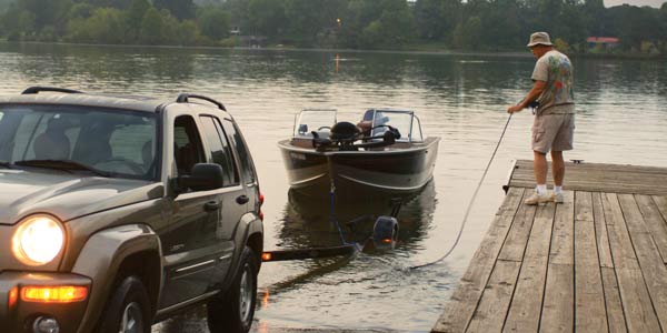 Man tying motorboat to dock