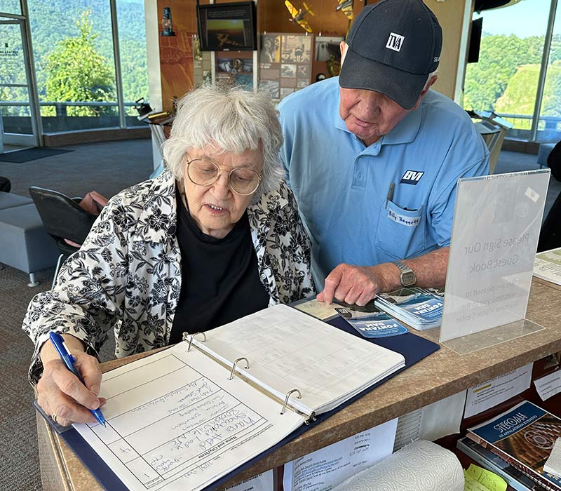 Judy Stearns signs the visitor log at the Fontana Dam Visitor Center.